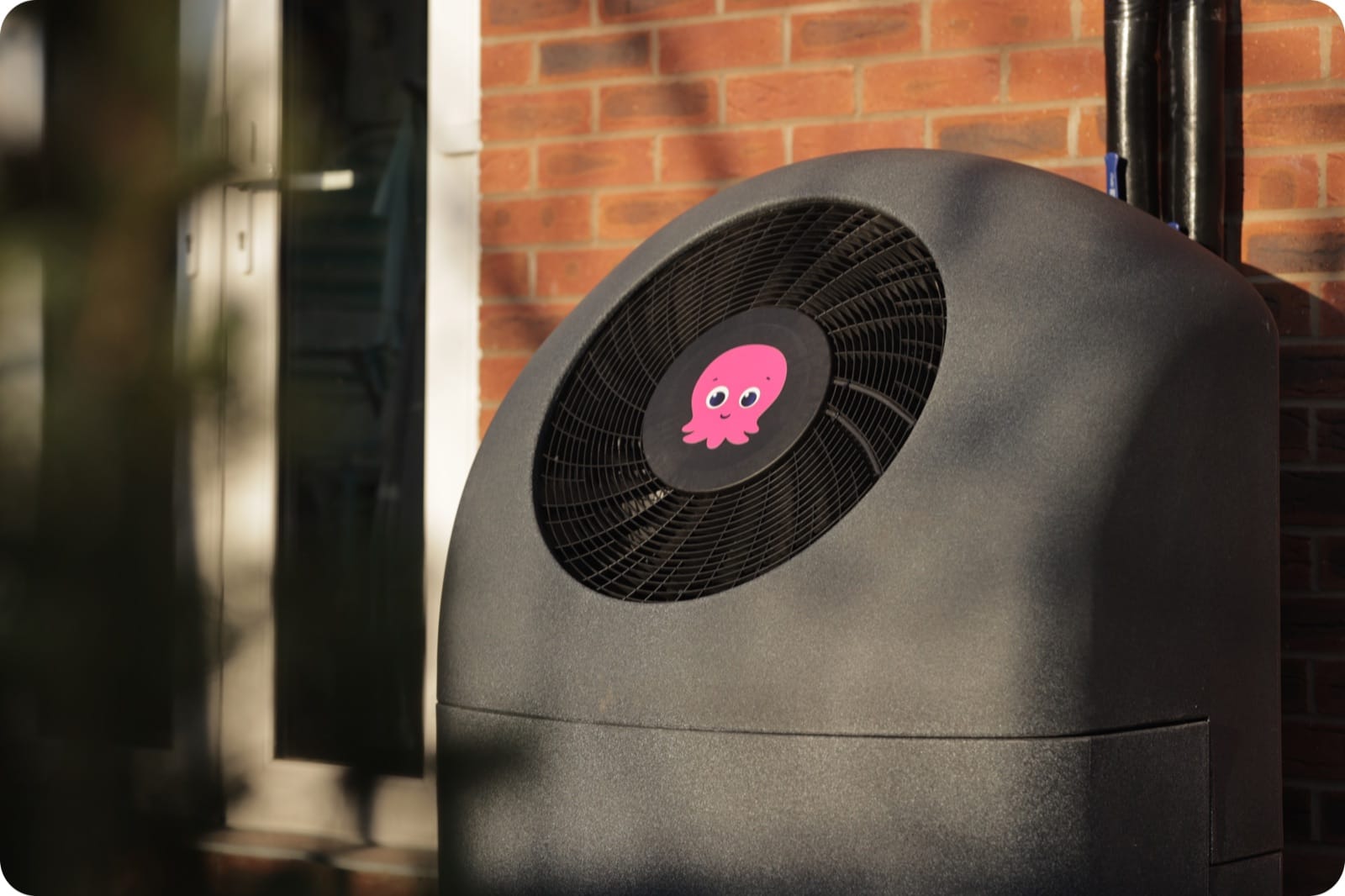 An Octopus Energy air source heat pump installed outside a home